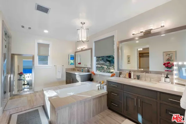 a large kitchen with kitchen island a sink appliances and a counter top space