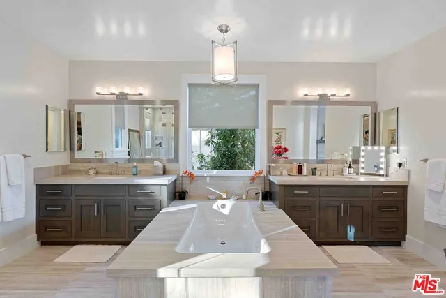 a large bathroom with a large tub and sink
