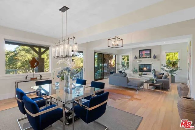 a living room with fireplace furniture and a large window