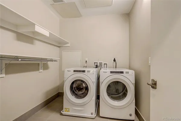 a bathroom with double sink and a mirror