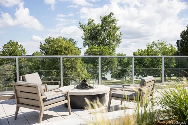 a view of a livingroom with furniture wooden floor and a large window