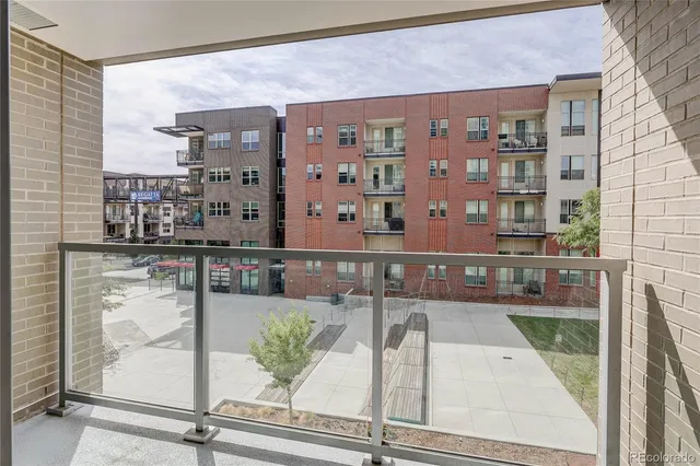 a view of a patio with dining table and chairs
