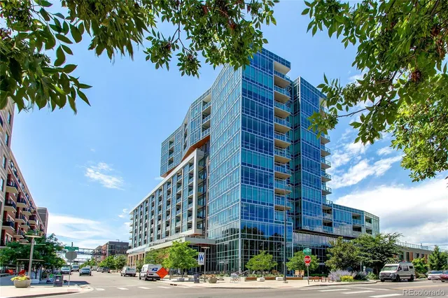 a city street lined with buildings and trees