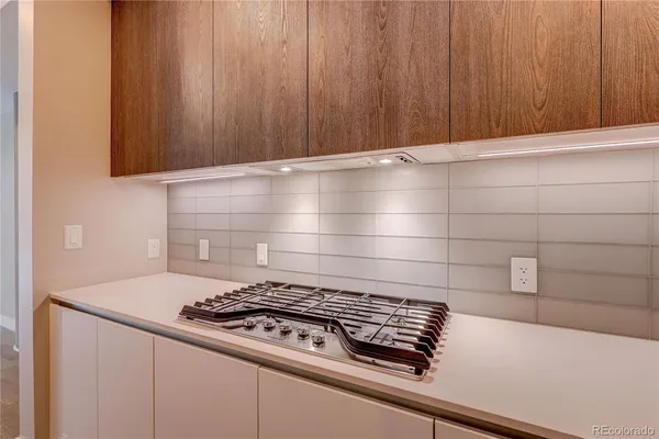 a stove top oven sitting inside of a kitchen
