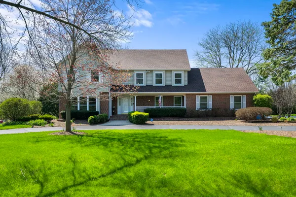 a view of a house with a yard porch and sitting area