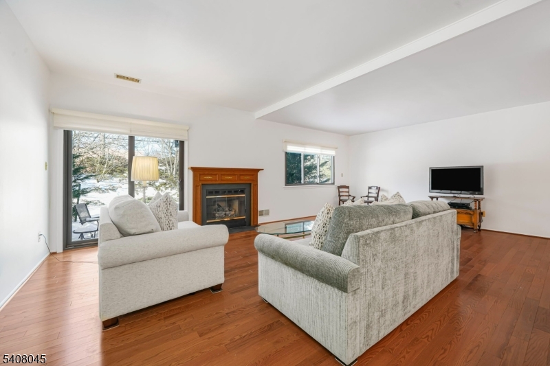175 Castle Ridge Drive East Hanover, NJ 07936 - Photo 13 of 34 a living room with furniture a flat screen tv and a fireplace