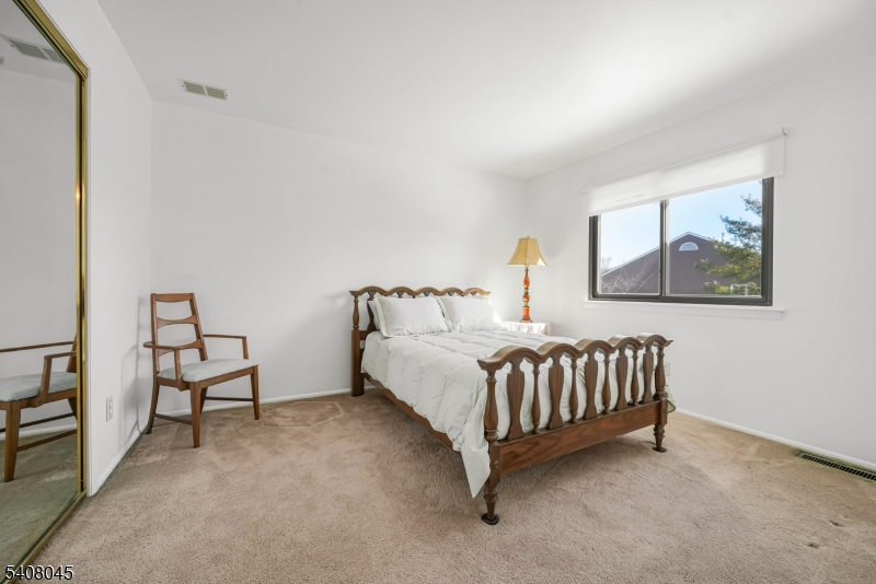 175 Castle Ridge Drive East Hanover, NJ 07936 - Photo 17 of 34 a white bed sitting in a room with a baby crib