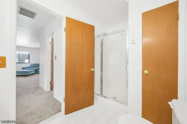 a view of a hallway with bathroom and bathroom