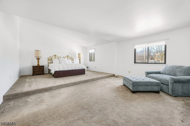 175 Castle Ridge Drive East Hanover, NJ 07936 - Photo 26 of 34 a spacious bedroom with a bed and couch