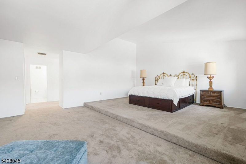 175 Castle Ridge Drive East Hanover, NJ 07936 - Photo 29 of 34 a spacious bedroom with a bed and a view of bathroom