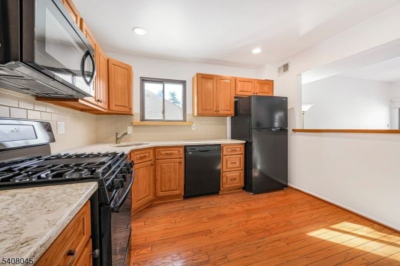 175 Castle Ridge Drive East Hanover, NJ 07936 - Photo 7 of 34 a kitchen with stainless steel appliances granite countertop a refrigerator and a stove top oven