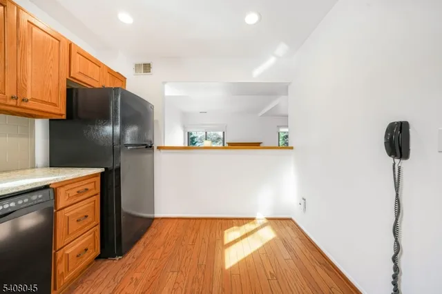 a kitchen with stainless steel appliances a refrigerator and a stove top oven