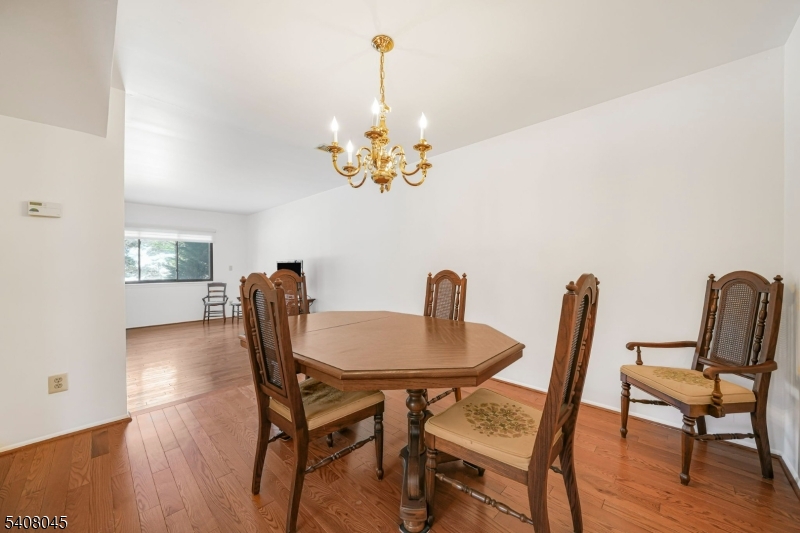 175 Castle Ridge Drive East Hanover, NJ 07936 - Photo 10 of 34 a view of a dining room with furniture and wooden floor