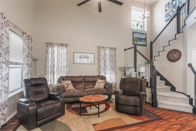 a living room with furniture and a chandelier