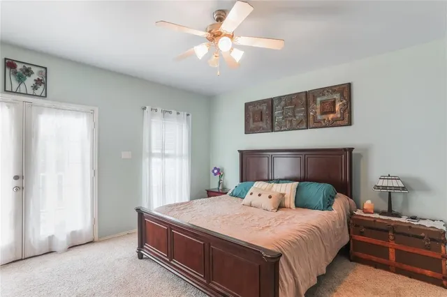 a bedroom with a large bed and a chandelier