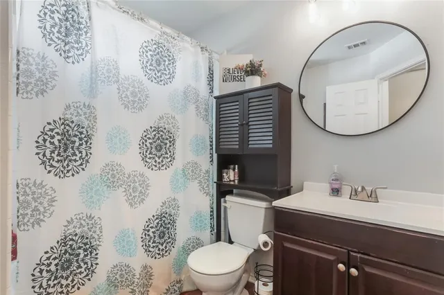 a bathroom with a sink a toilet and a mirror