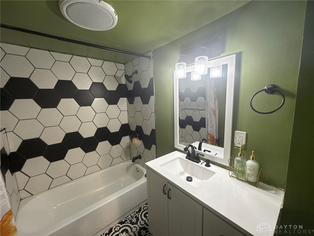 1125 West High Street Springfield, OH 45506 - Photo 5 of 39 This bathroom features unique patterned tilework and a bright vanity, perfect for daily routines.