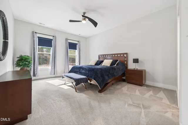a bathroom with a double vanity sink toilet mirror and shower