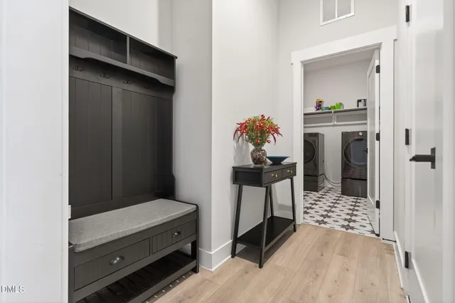 a kitchen with stainless steel appliances granite countertop a sink a stove a refrigerator and island with wooden floor