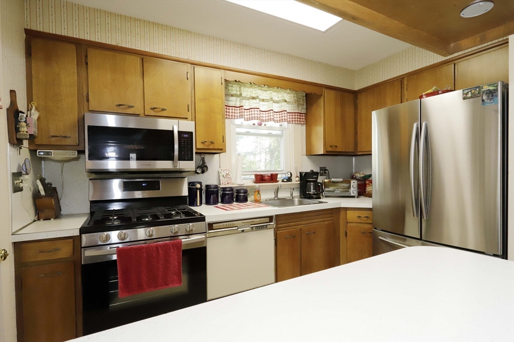 5 Anthony Street Acushnet, MA 02743 - Photo 22 of 37 a kitchen with stainless steel appliances a stove a sink a microwave a refrigerator and cabinets