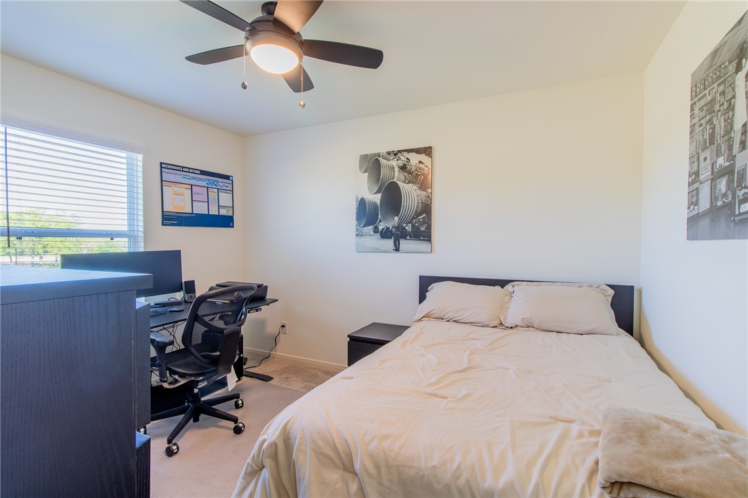 6029 Toby Bend Bryan, TX 77807 - Photo 22 of 25 a bedroom with a bed and a desk
