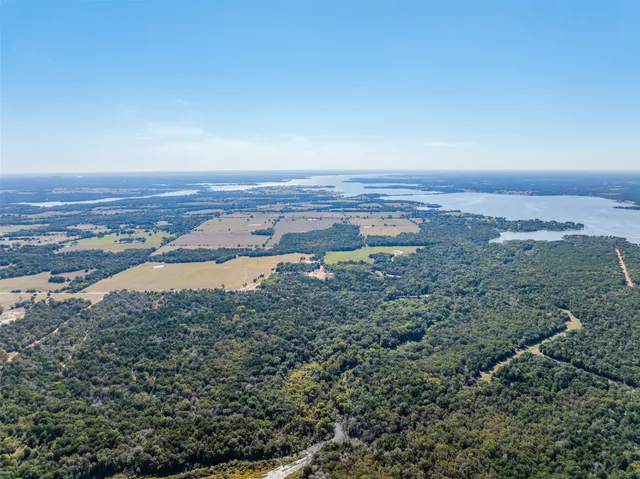 a view of a lake with houses in the back
