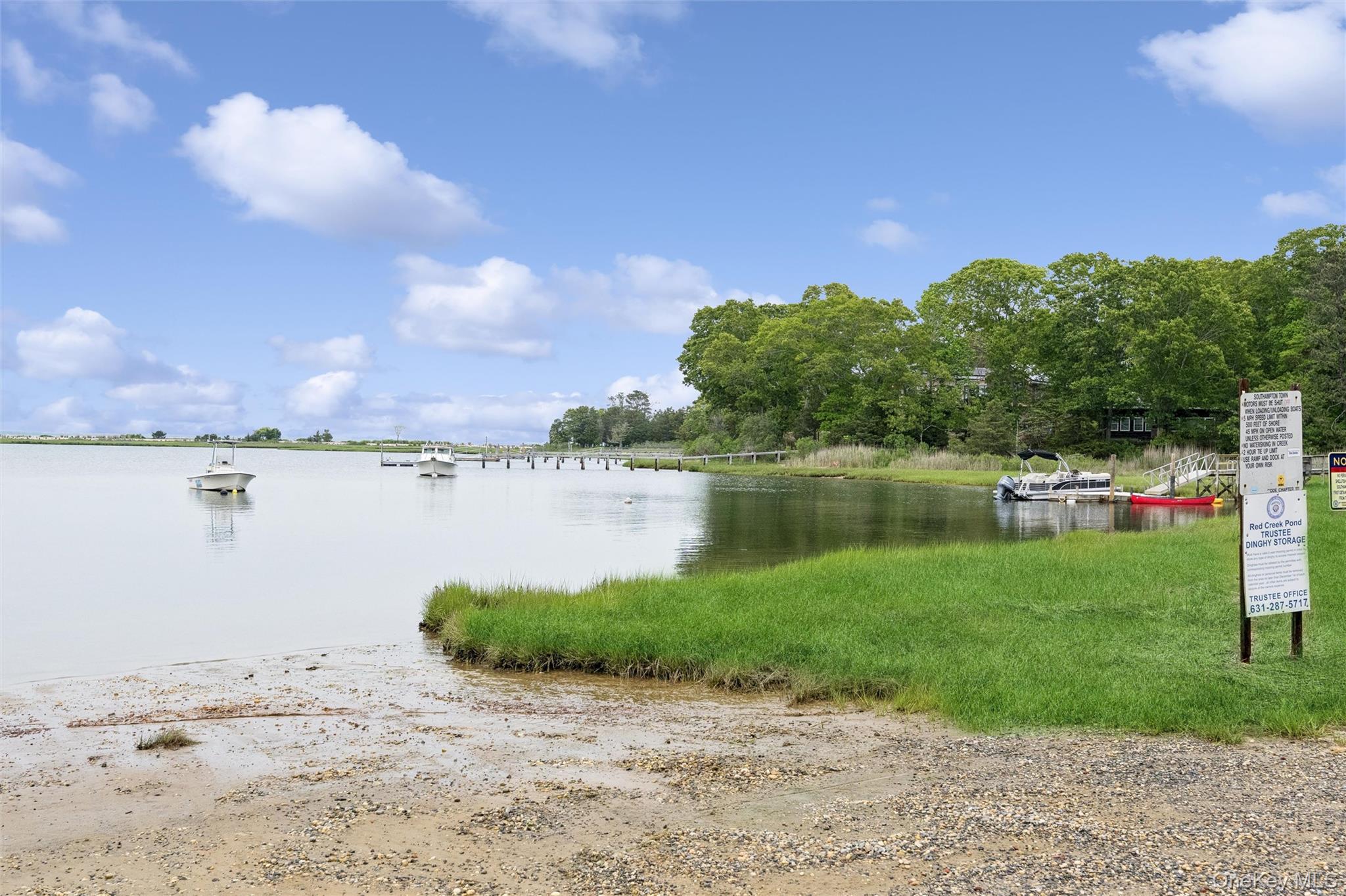 131 Red Creek Road Hampton Bays, NY 11946 - Photo 28 of 35 a view of a lake with a big yard