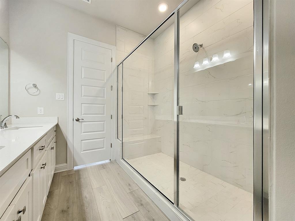 601 C-Bar Ranch Trail, Unit 14 Cedar Park, TX 78613 - Photo 14 of 22 a bathroom with a granite countertop sink a shower and a mirror