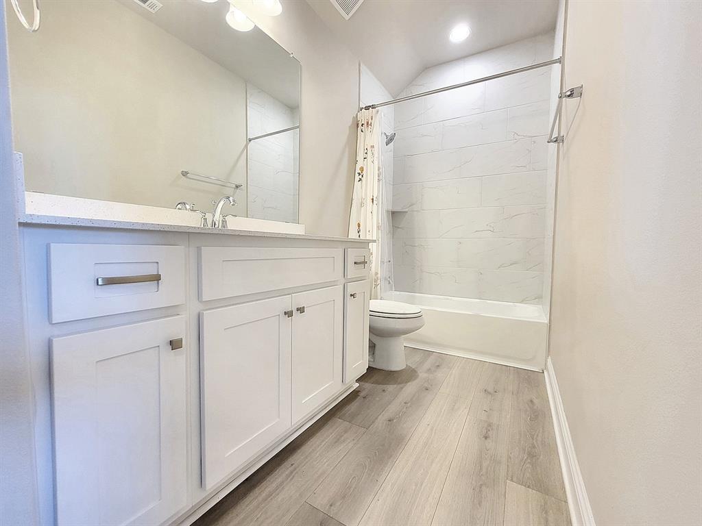 601 C-Bar Ranch Trail, Unit 14 Cedar Park, TX 78613 - Photo 19 of 22 a bathroom with a bathtub shower sink vanity and toilet