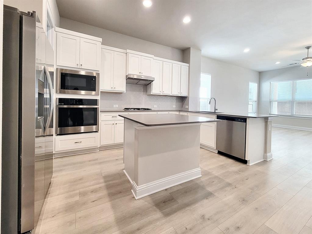 601 C-Bar Ranch Trail, Unit 14 Cedar Park, TX 78613 - Photo 6 of 22 a kitchen with stainless steel appliances granite countertop a stove a sink and a refrigerator