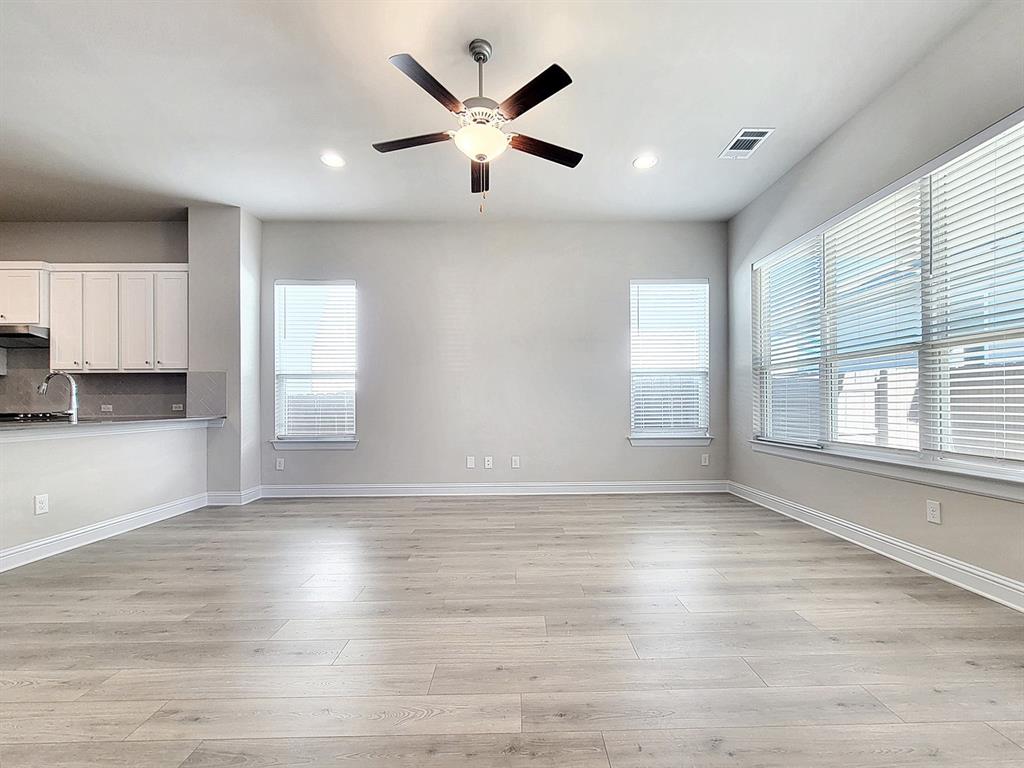 601 C-Bar Ranch Trail, Unit 14 Cedar Park, TX 78613 - Photo 7 of 22 a view of empty room with wooden floor and fan