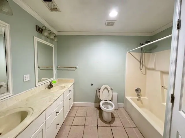 a bathroom with a granite countertop sink a toilet and shower