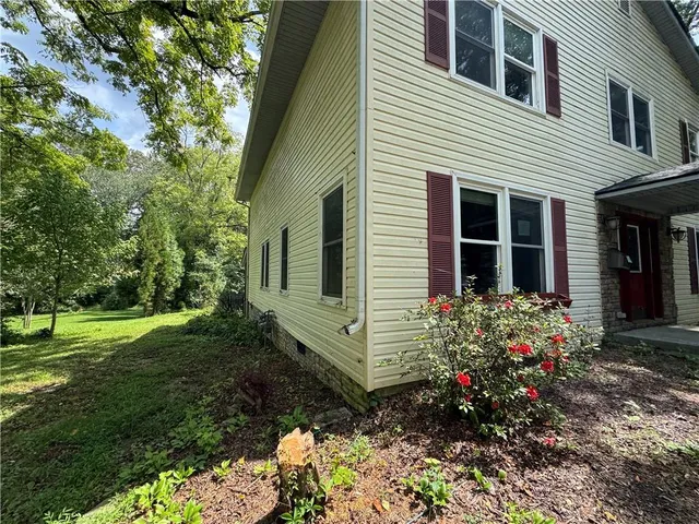 a view of a house with a yard and garden