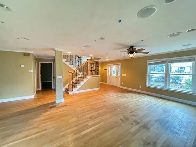 wooden floor in an empty room with a window