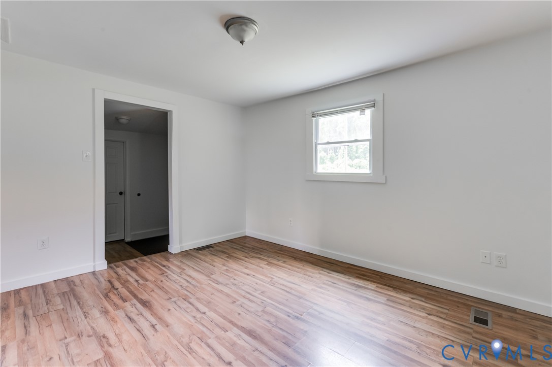 661 CCC Road Crewe, VA 23930 - Photo 11 of 38 Spacious room featuring wood-finish flooring, whit