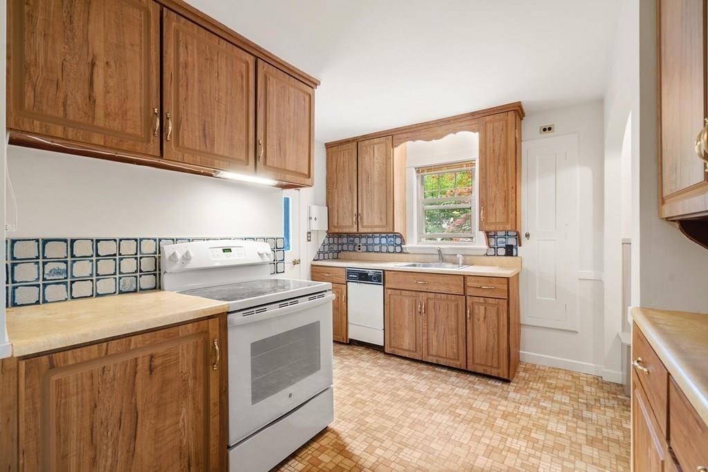 30 Pine Plain Road Wellesley, MA 02481 - Photo 12 of 27 a kitchen with a sink stove and cabinets