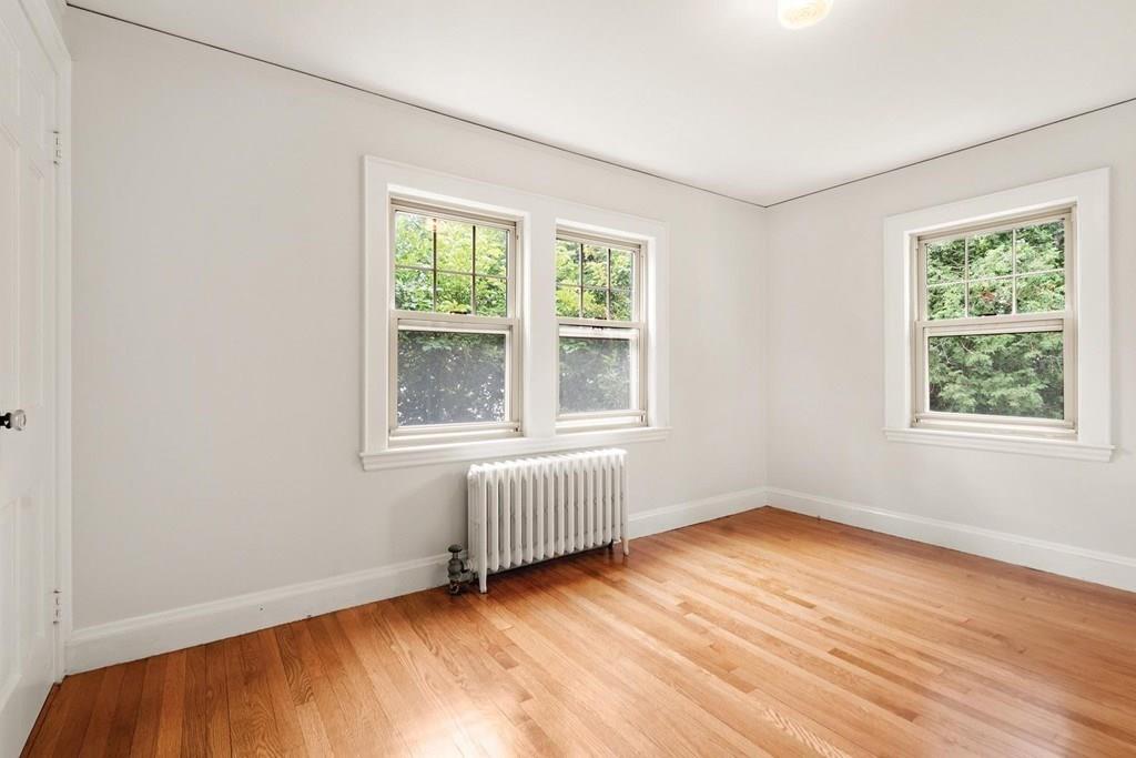 30 Pine Plain Road Wellesley, MA 02481 - Photo 20 of 27 an empty room with wooden floor and windows