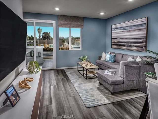 a living room with furniture and a potted plant