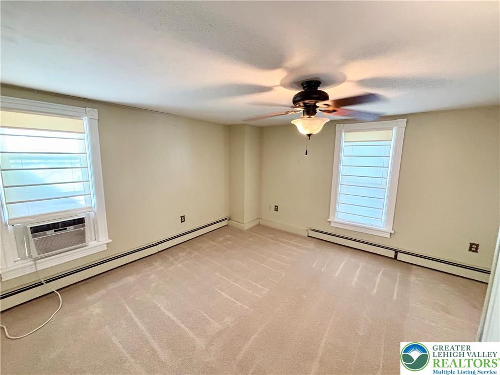 7241 Decatur Street New Tripoli, PA 18066 - Photo 21 of 36 A well-lit bedroom features plush carpeting and a convenient window unit.