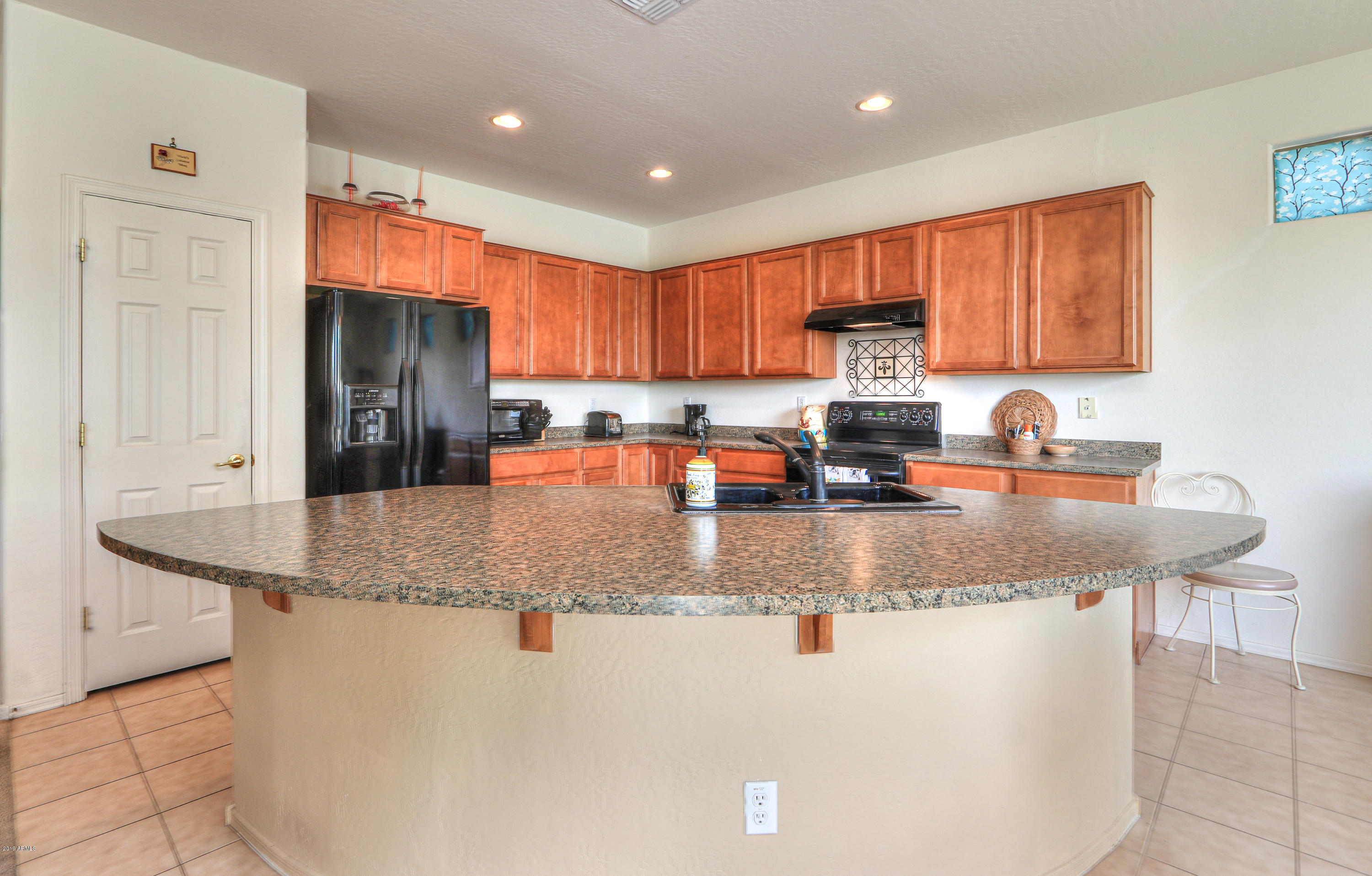 42485 Abbey Road Maricopa, AZ 85138 - Photo 15 of 74 a kitchen with stainless steel appliances granite countertop a sink a stove and a refrigerator