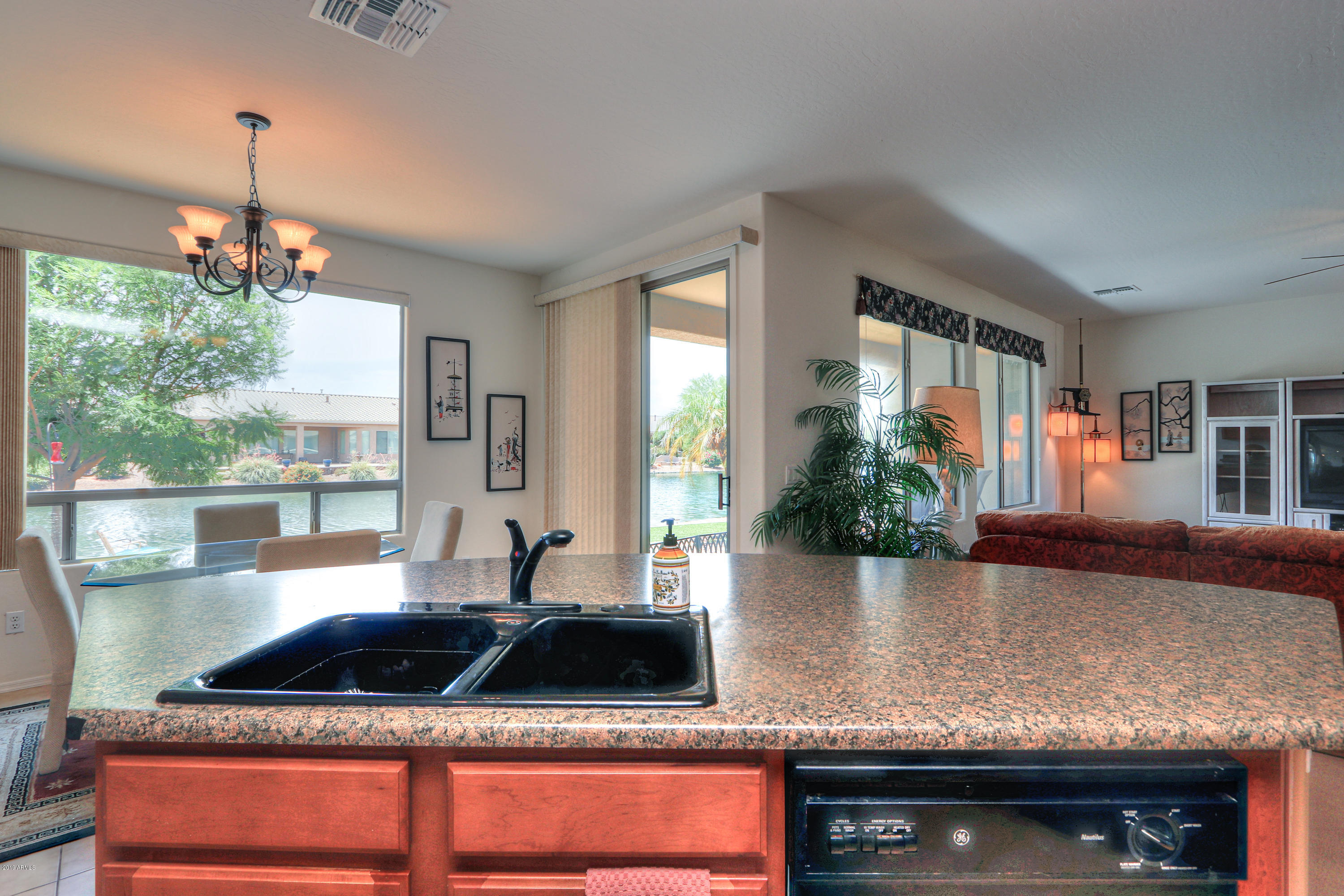 42485 Abbey Road Maricopa, AZ 85138 - Photo 18 of 74 a kitchen with a granite countertop sink and cabinets