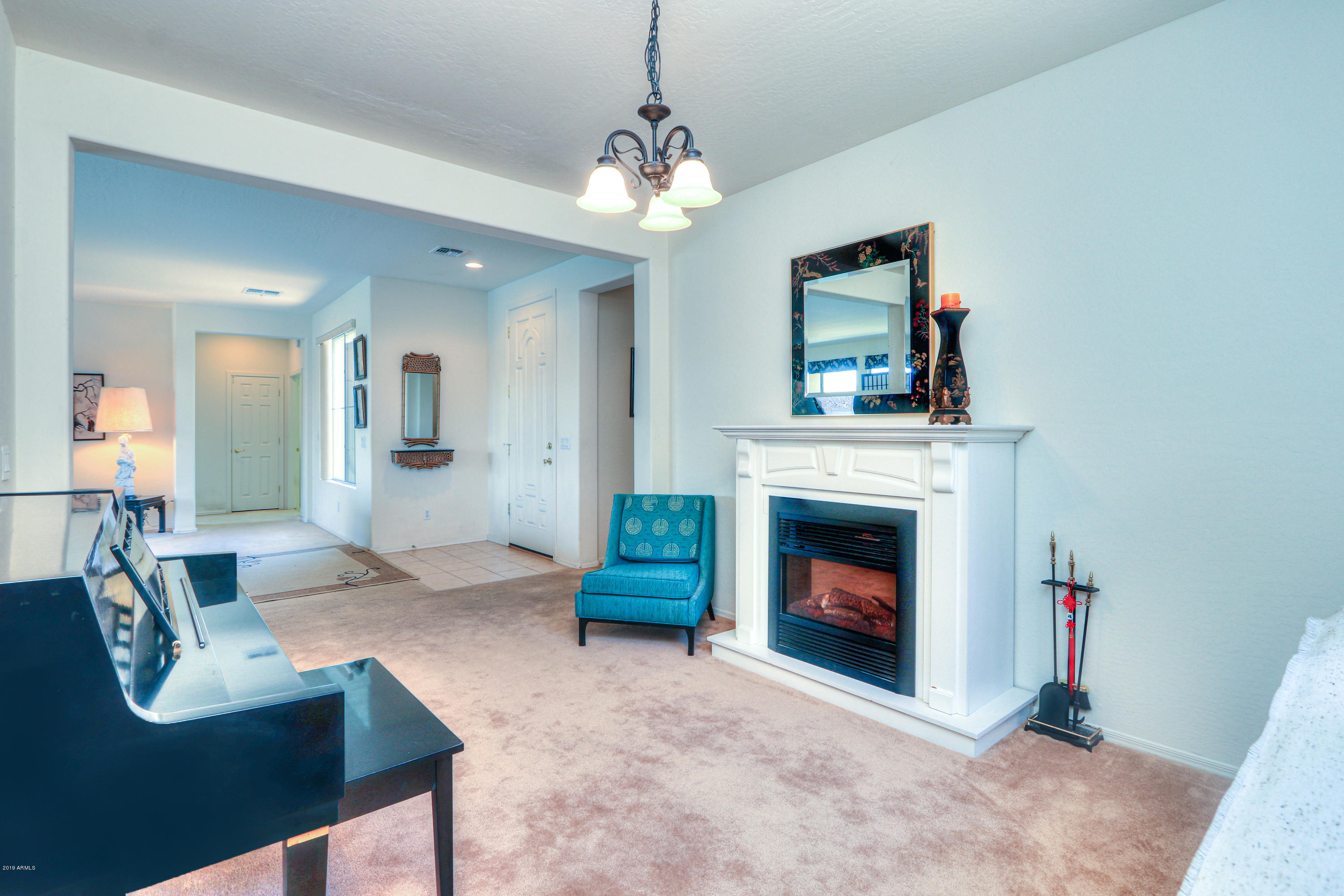 42485 Abbey Road Maricopa, AZ 85138 - Photo 25 of 74 a living room with furniture and a fireplace