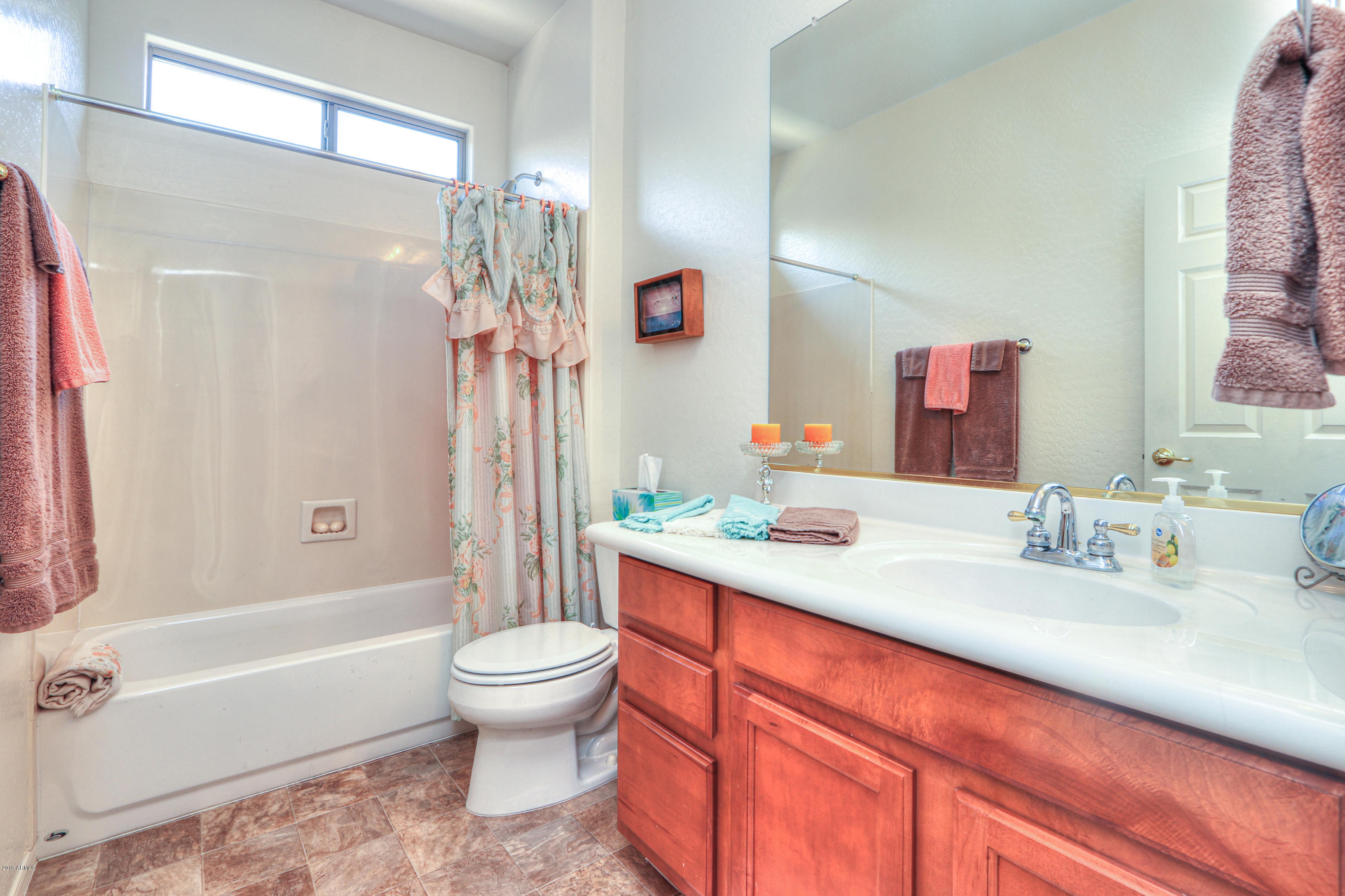 42485 Abbey Road Maricopa, AZ 85138 - Photo 41 of 74 a bathroom with a sink a toilet and a large mirror