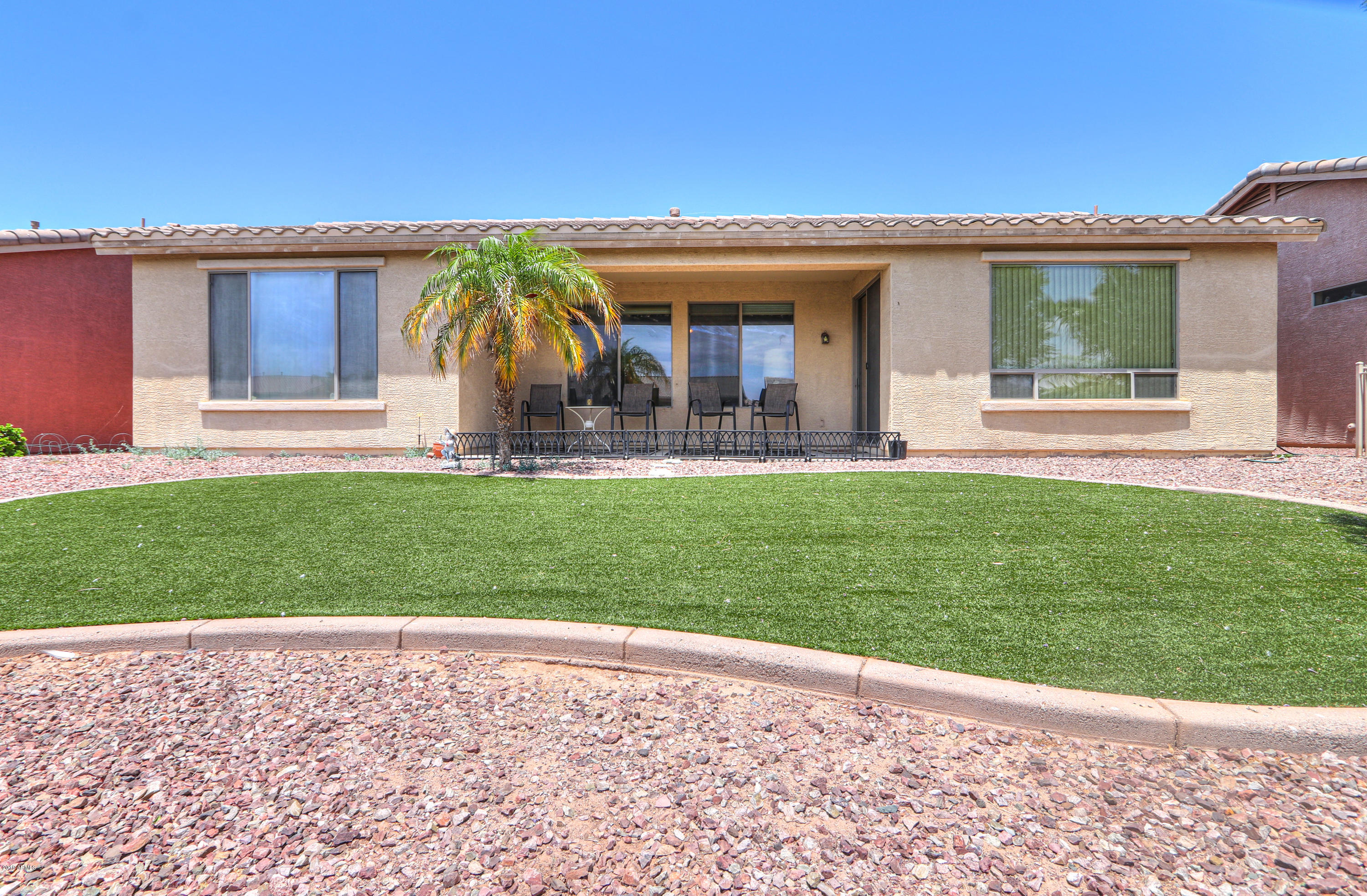 42485 Abbey Road Maricopa, AZ 85138 - Photo 49 of 74 a front view of a house with a garden and yard