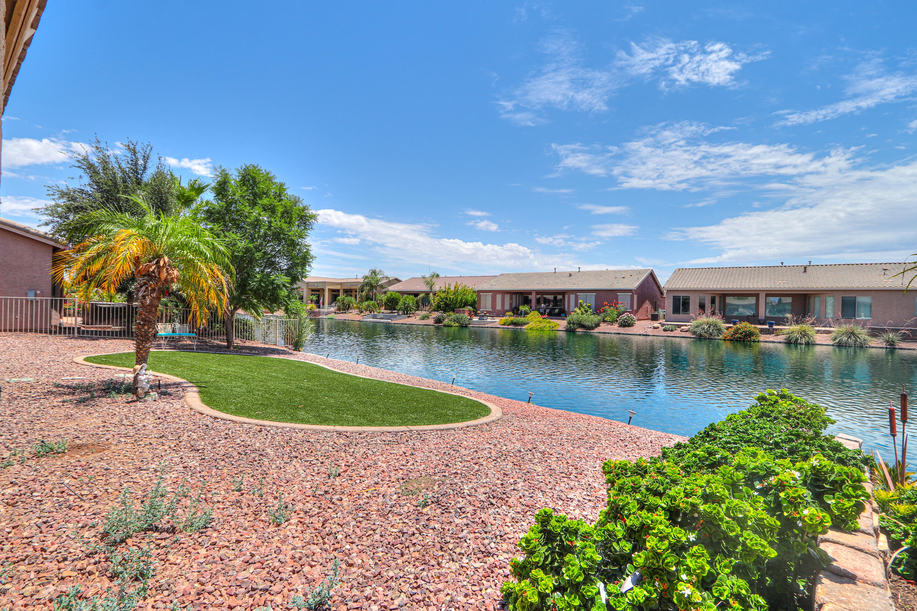 42485 Abbey Road Maricopa, AZ 85138 - Photo 51 of 74 a view of a lake with a house in the background