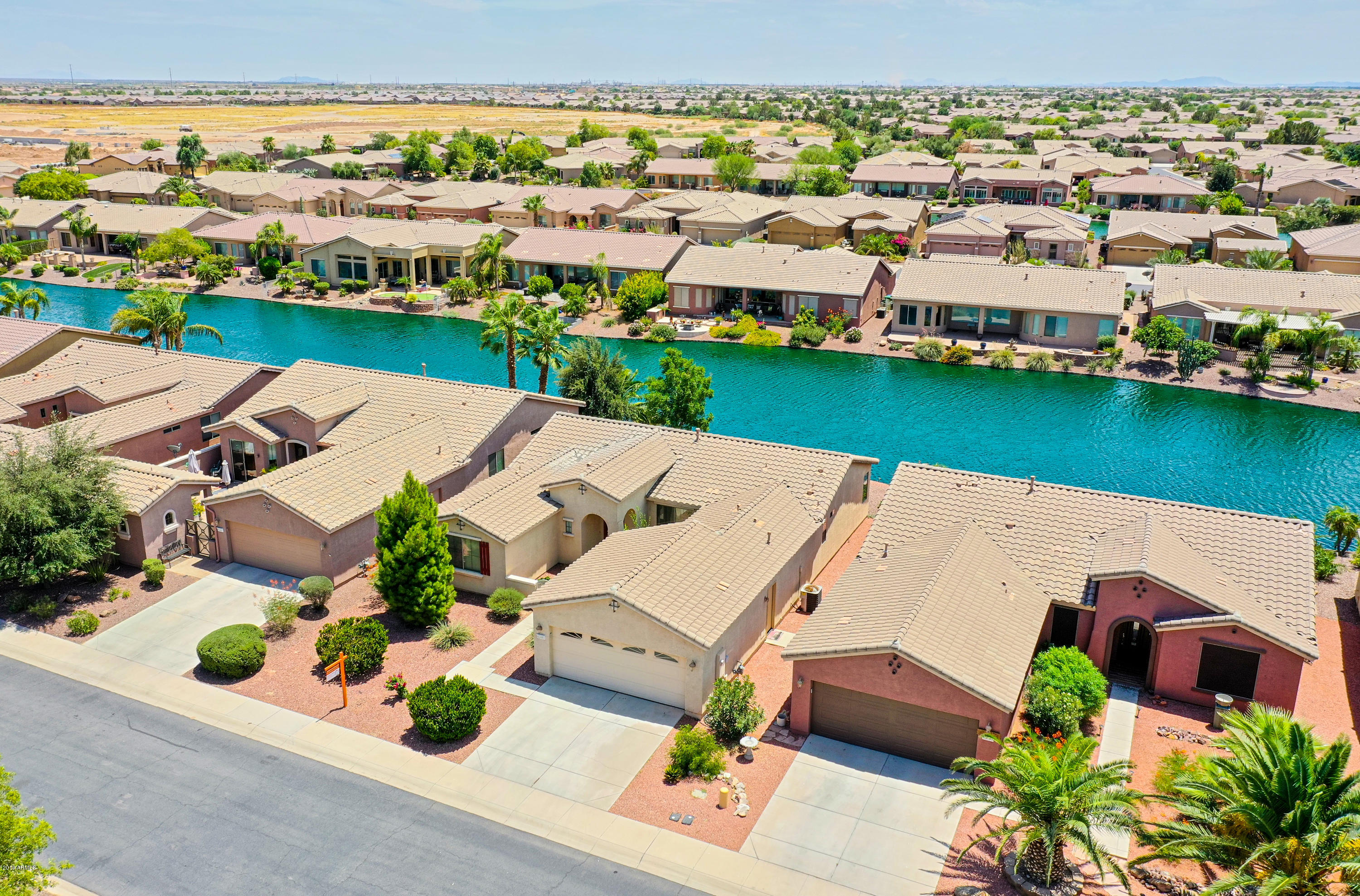 42485 Abbey Road Maricopa, AZ 85138 - Photo 56 of 74 an aerial view of a house with a garden and lake view