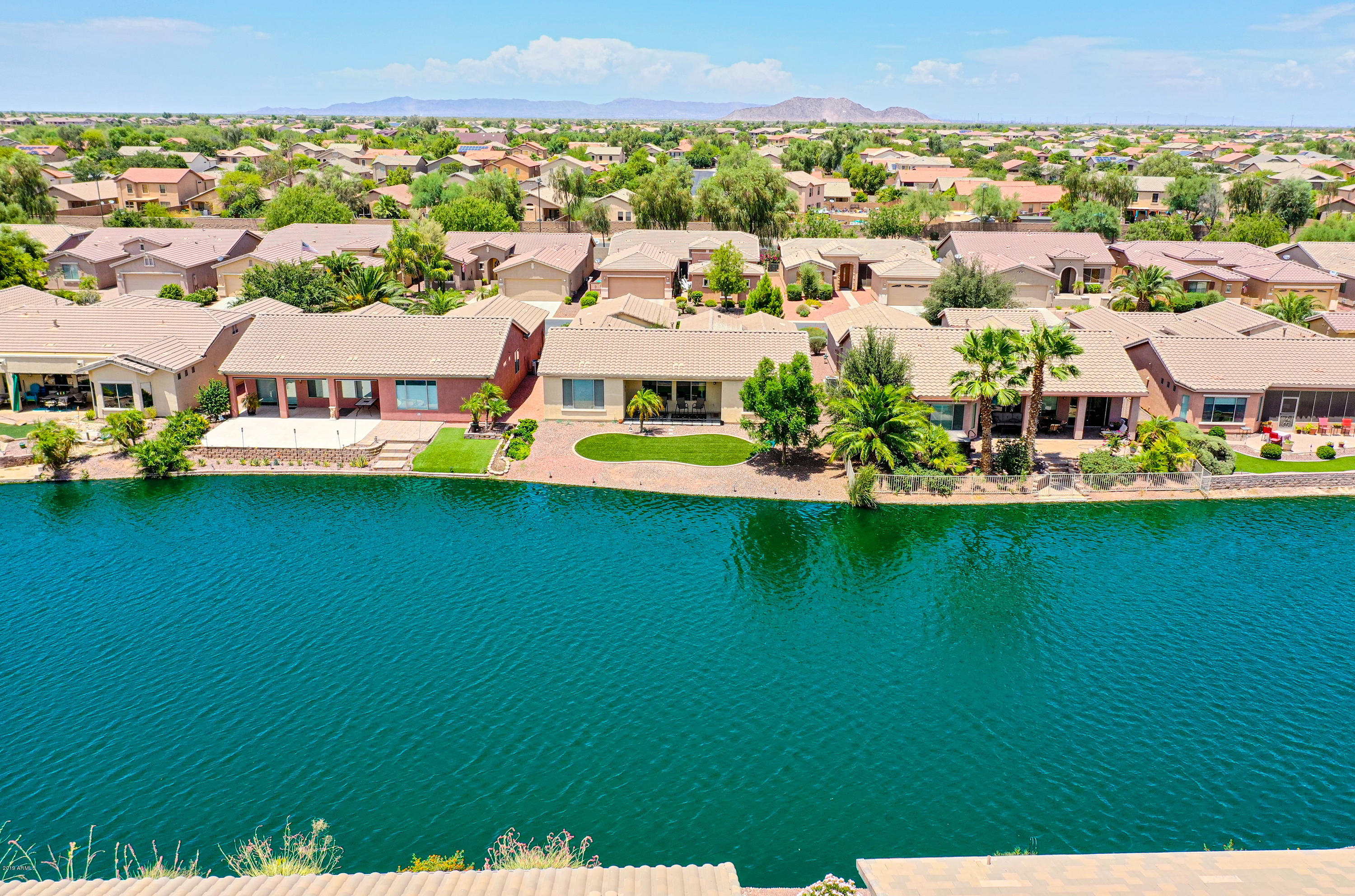 42485 Abbey Road Maricopa, AZ 85138 - Photo 60 of 74 an aerial view of a house with a garden and lake view