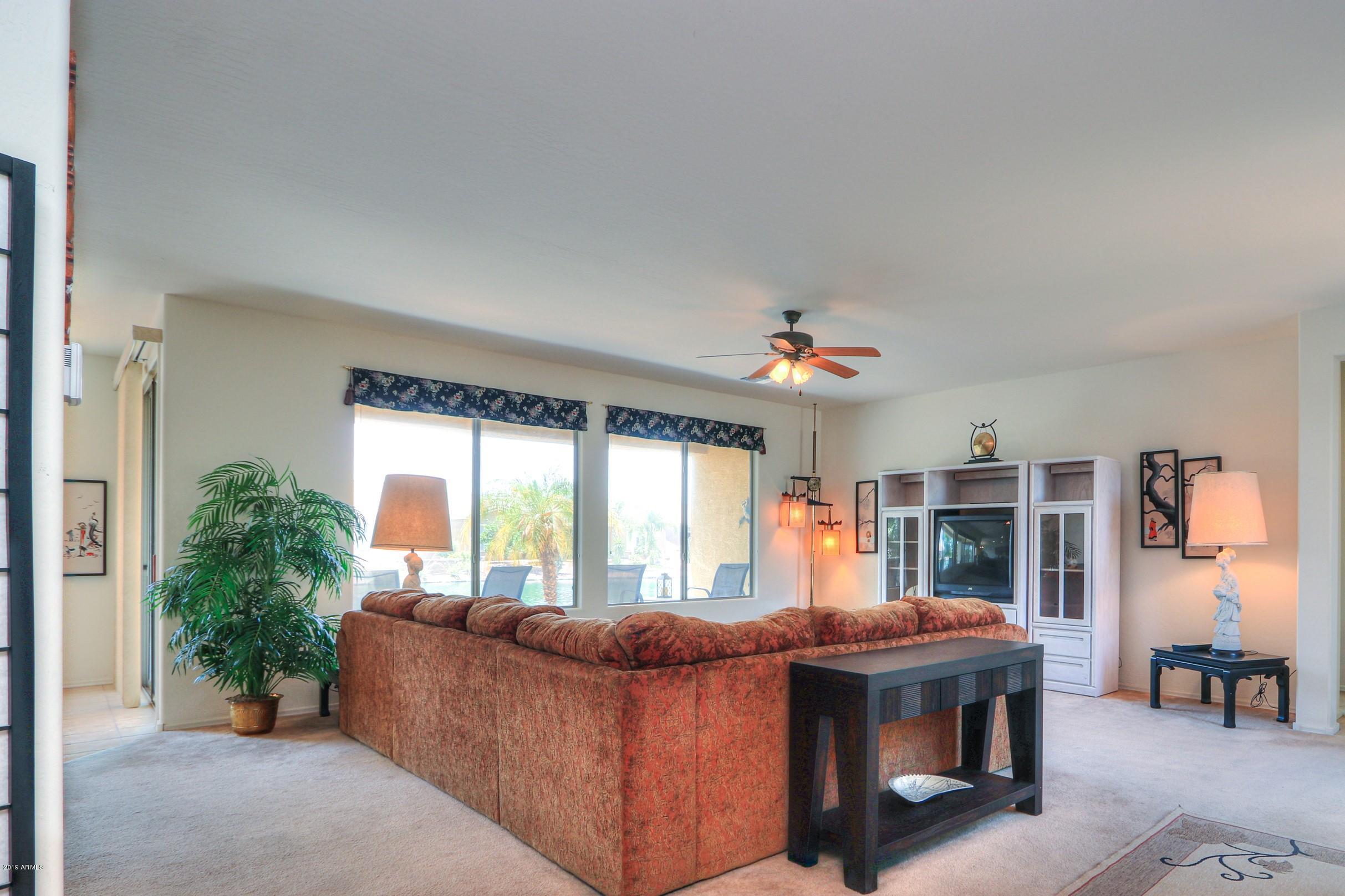 42485 Abbey Road Maricopa, AZ 85138 - Photo 10 of 74 a living room with furniture and a large window