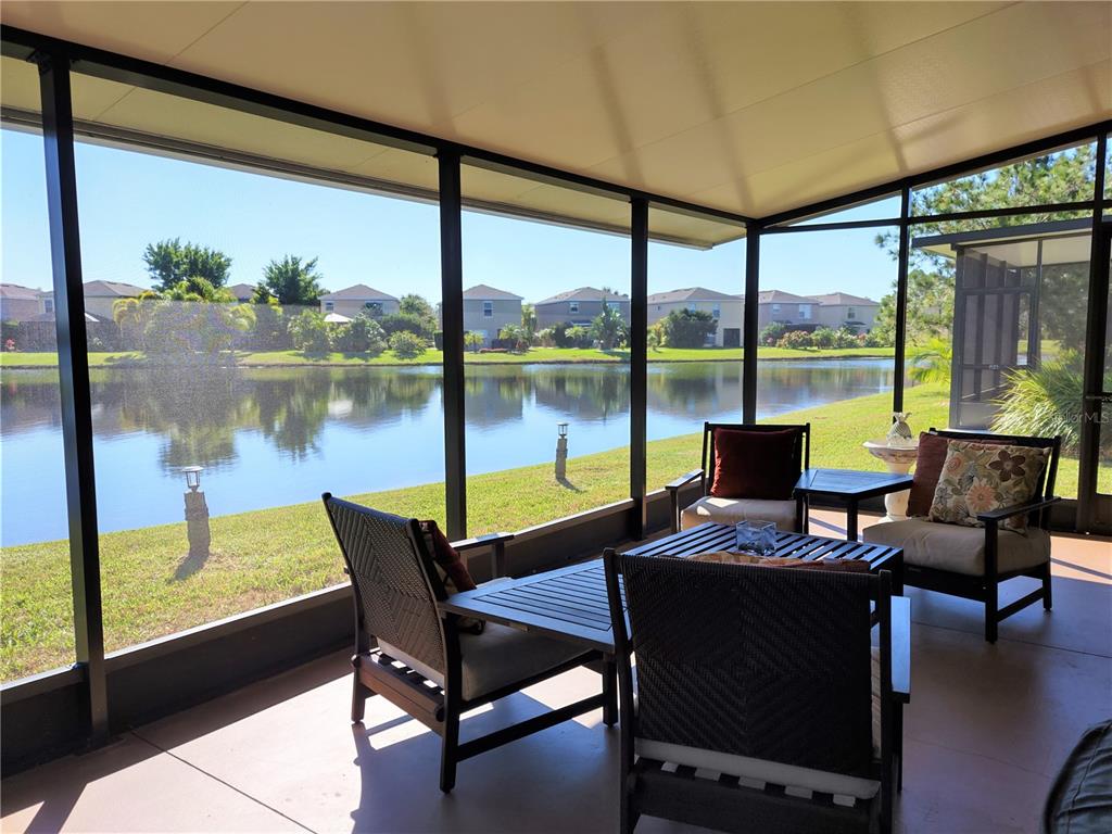 11997 Tempest Harbor Loop Venice, FL 34292 - Photo 11 of 52 a view of a porch with furniture and a yard