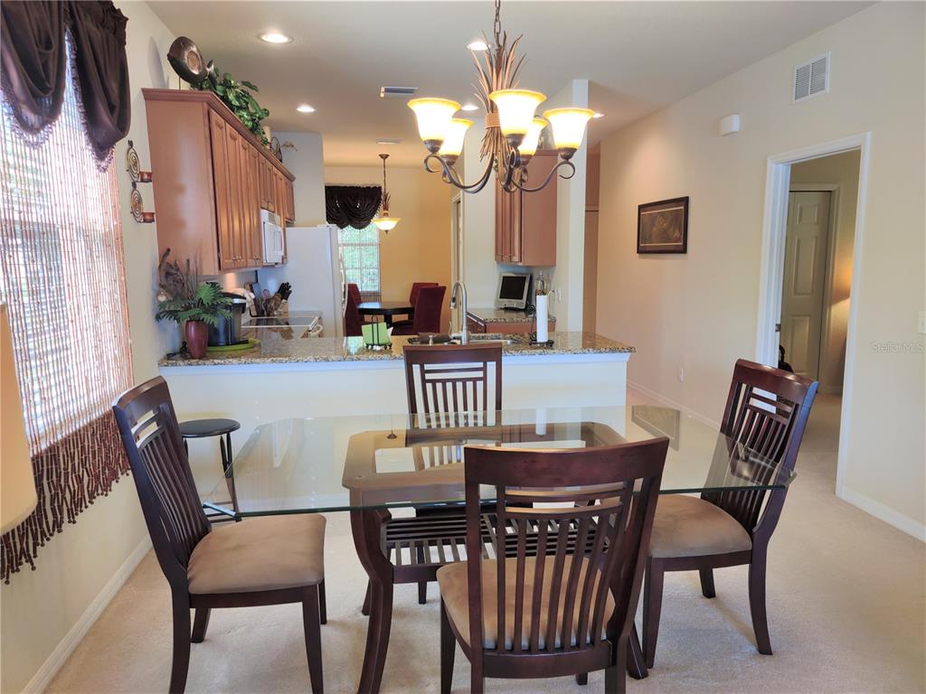 11997 Tempest Harbor Loop Venice, FL 34292 - Photo 18 of 52 a view of a dining room with furniture and a chandelier